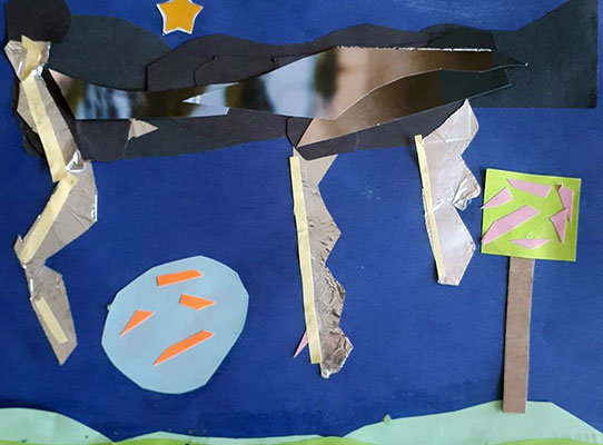 Paper cutouts depicting lightning in the sky and a grassy scene on the ground.